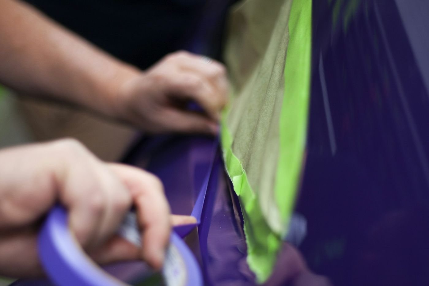 Titan film being laid and squeegeed onto a vehicle panel