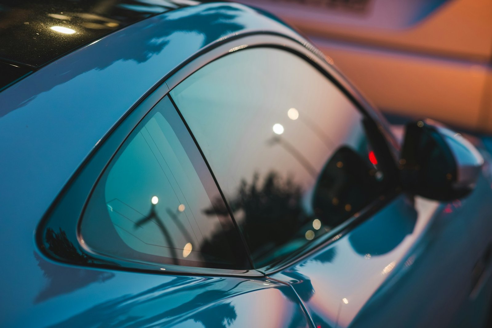 Tinted rear quarter window on a sports car, viewed from the outside